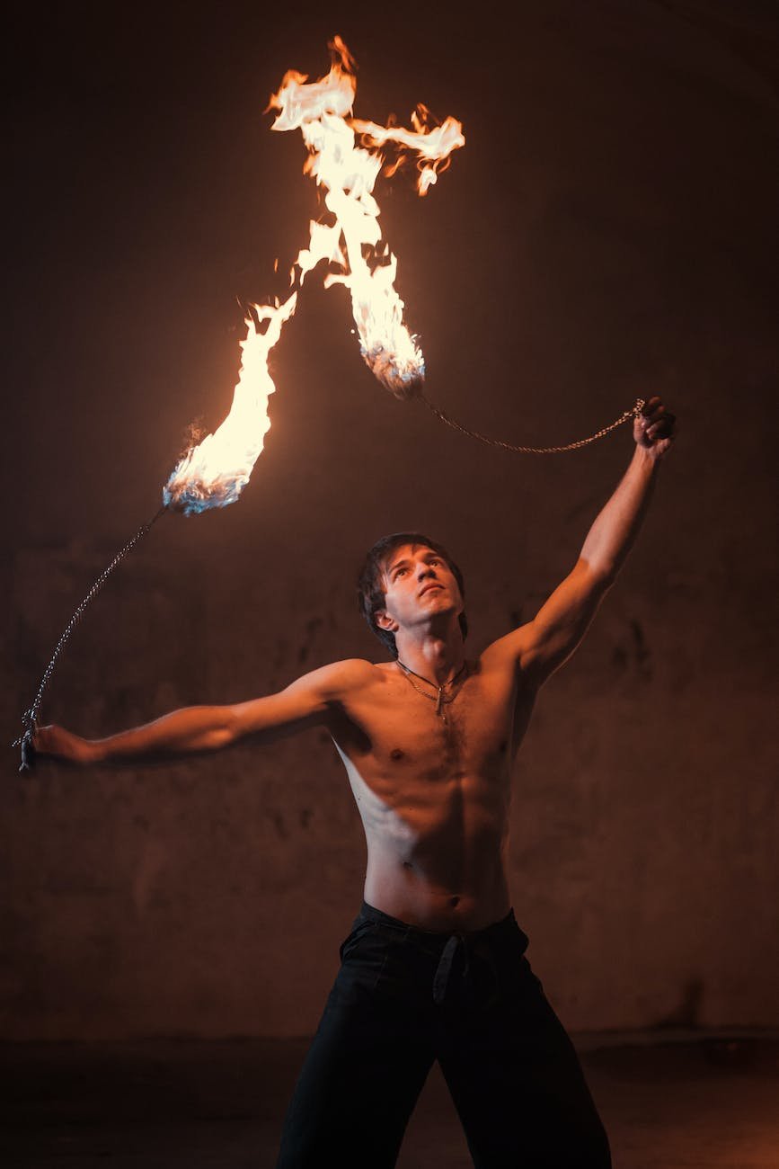 shirtless man fire dancing